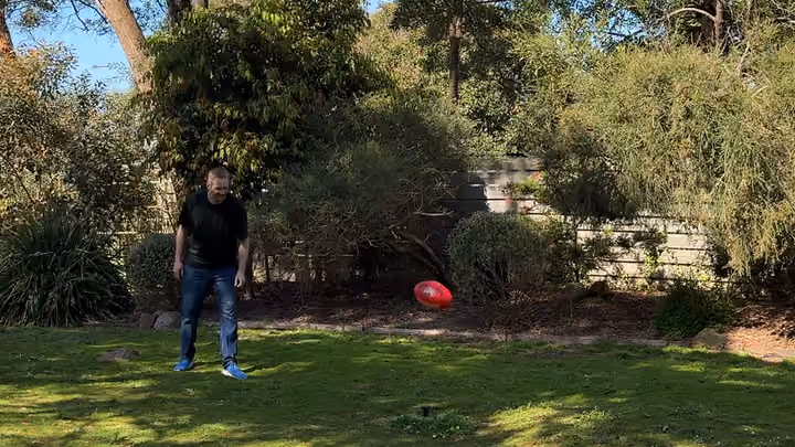In the backyard, the prototype stands up out of the turf as the ball flies away.